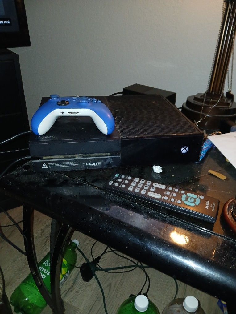 Black Xbox One And All The Cords And Blue Controller