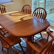 Solid Oak Dining Table with two leaves and 6 chairs (2 captain)