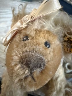 Vintage Knickerbocker Mohair Teddy Bear   Uniquely Shaped Collectible Bear is made of cream-colored mohair. This collectible plush has a cream satin r