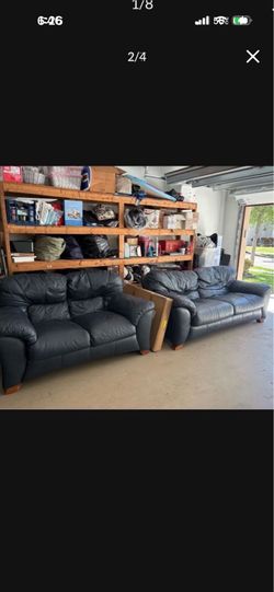Navy blue leather couch and loveseat