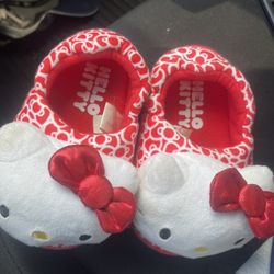 This is a pair of Hello Kitty by Sanrio red and white plush slippers. Size 7T-8T