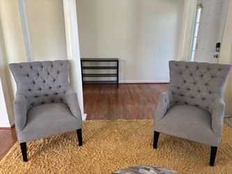 Two wing back chairs and ottoman