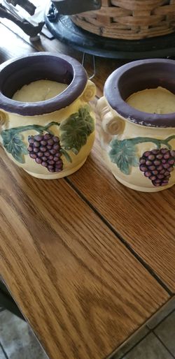 Two decorative candle holders with candles
