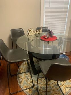 Glass Dining Counter Top table With Leather Chairs.