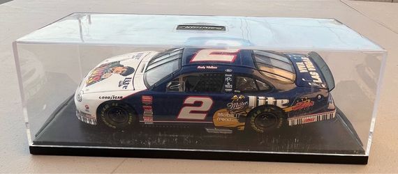 24 scale diecast model of the 1998 Ford Taurus NASCAR stock car driven by Rusty Wallace. It features a special Elvis Presley / Miller Lite tribute