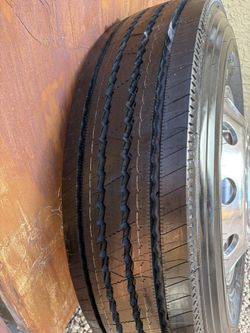 One new Michelin XZE2 steer tire with rim