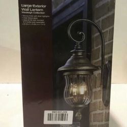 The vintage appeal of aged iron lends classic charm to the Brimfield Outdoor Wall Lantern from Home Decorators Collection. This weather-resistant out