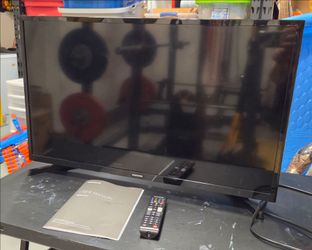 Samsung 32" Smart TV with remote and user manual.