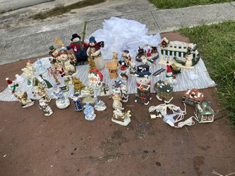 collection of vintage holiday and Christmas decorative figurines, including resin and ceramic snowmen, Santa Claus figures, angels, tiny houses, a gol