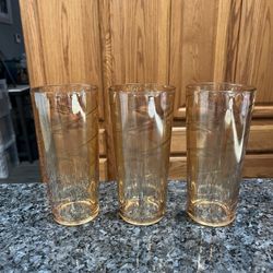 Vintage Set of 3 Jeannette Carnival Marigold Tumblers.  Design Optic Swirl.  Size approximately 6 1/2 inches tall.  Capacity 14 ounces.  Preowned Exce