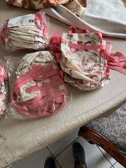 New fabric gift bags with floral designs; each pack contains 8 bags, and there are 4 packs.