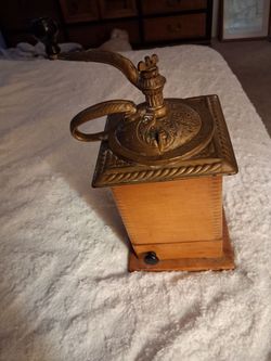 Antique box styled hand cranked coffee grinder with ornate top