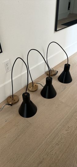 3 black and brass pendant lights