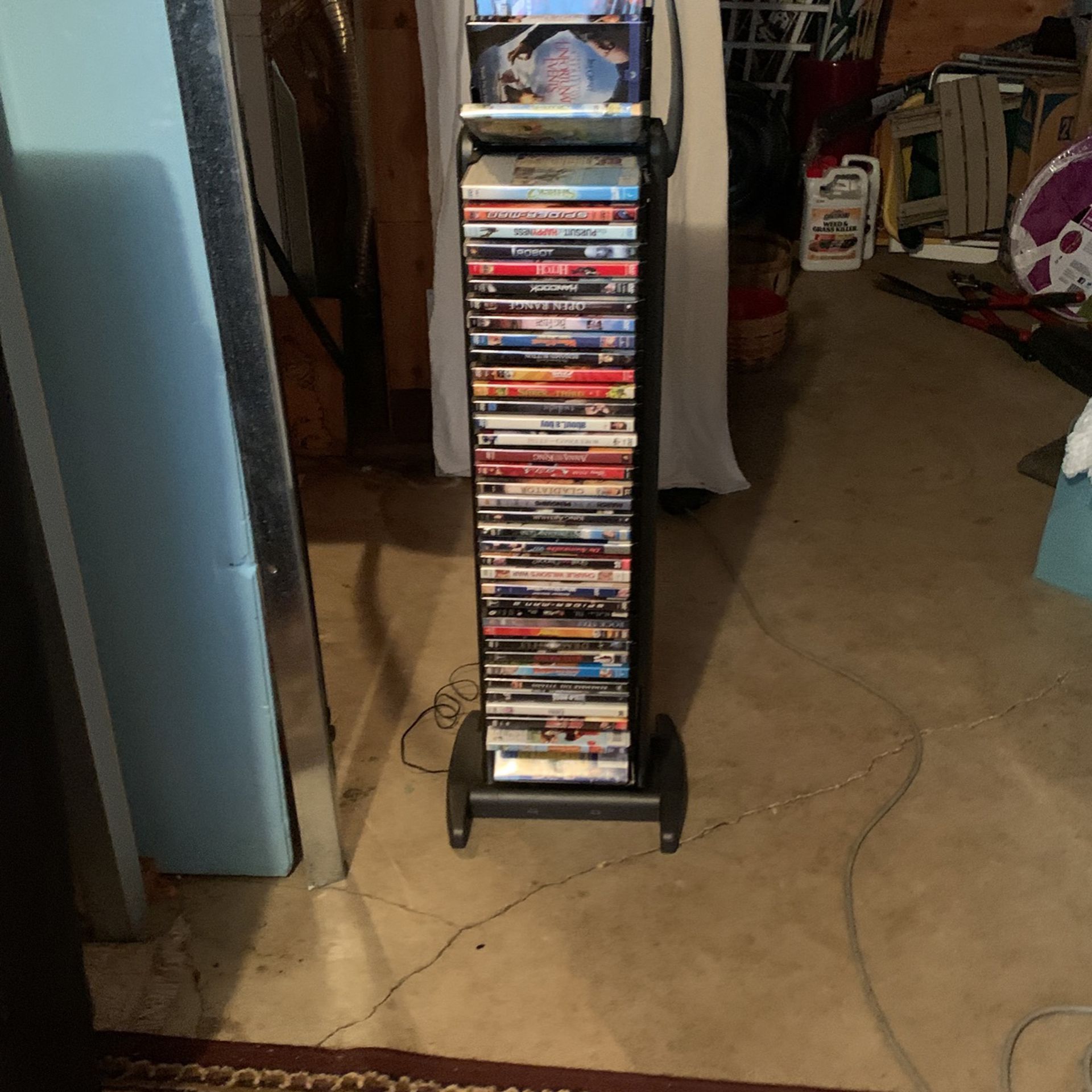 DVD Stand Black Includes Movies - Rotates With Light. 45 H/10 W/ 14 D.