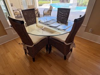 54” round glass top dining table with 4 chairs.  Excellent condition.