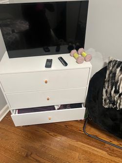 White dresser with lounge chair and accessories