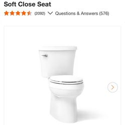 KOHLER Gleam 12 in. Rough In 2-Piece 1.28 GFP Single Flush Elongated Chair Height Toilet in White with Soft Close Seat