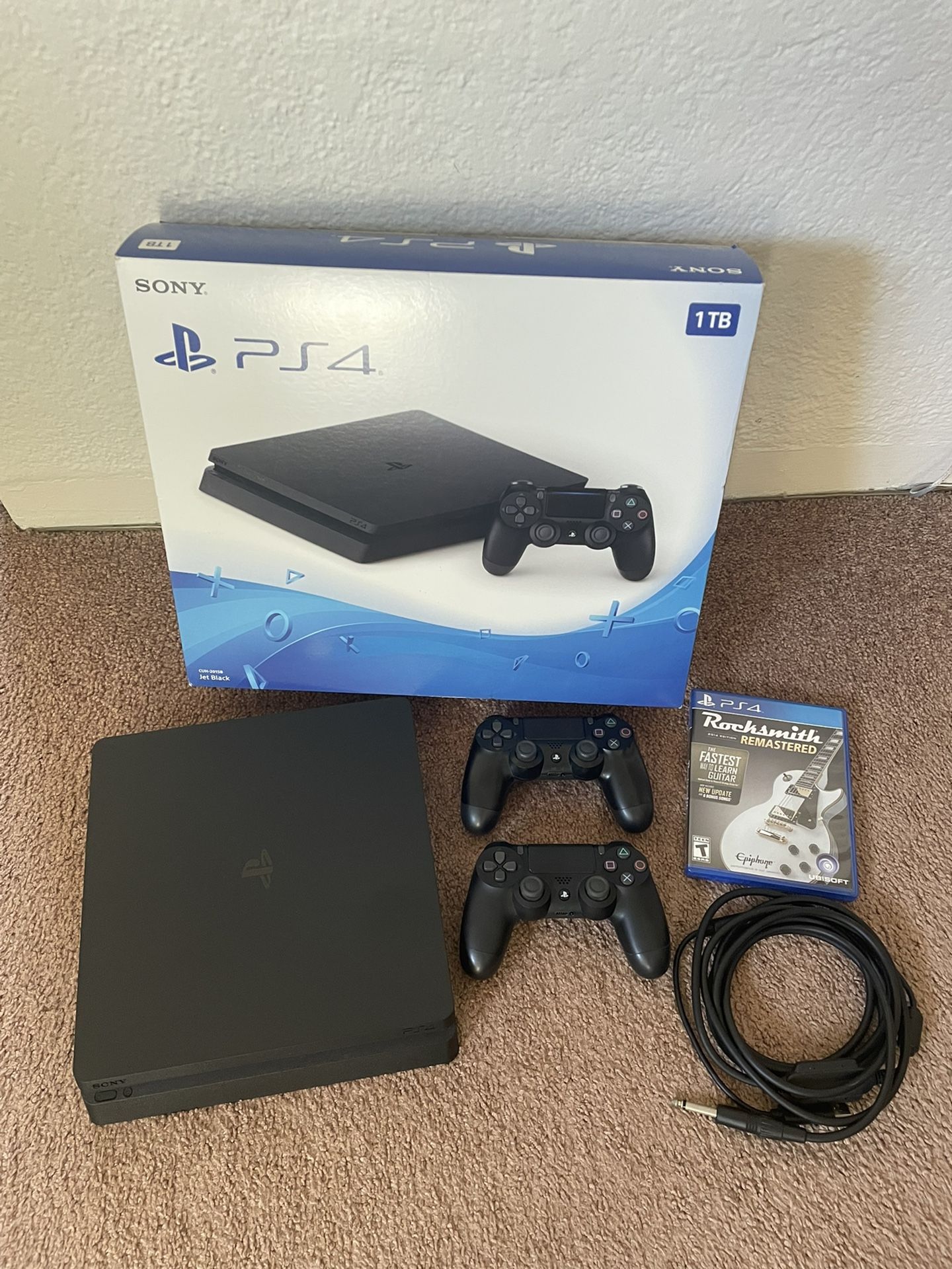 PLAYSTATION PS4 Slim 1TB w/two controllers and Rocksmith Guitar