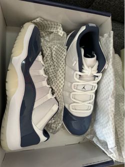 Nike Air Jordan 11 Retro Low Diffused Blue sneakers with white mesh and patent leather overlays in blue.