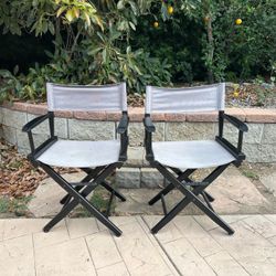 2  gray and black folding directors chairs