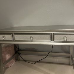 mirrored / silver console or vanity table with crystal-style drawer knobs, in good condition and modern/glam style.