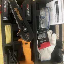 New 6 inch mini chainsaw it comes with two batteries, safety gloves, and safety glasses