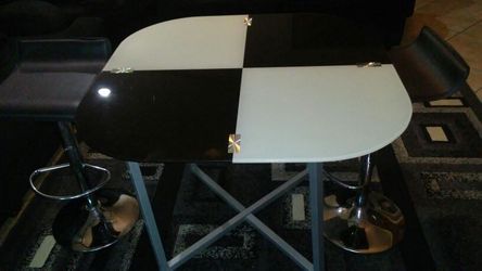 Unique table with two bar stools