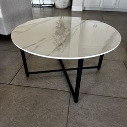 Elegant round marble style coffee table with black metal legs