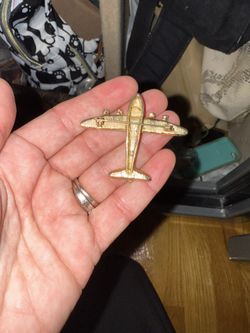 vintage gold-tone airplane brooch adorned with clear rhinestones. 