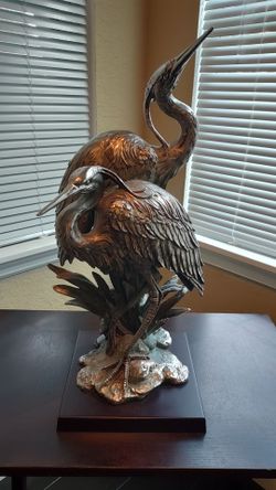 Two Bronze grey heron crane birds