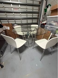 Perigold glass table + 4 white crate and barrel chairs