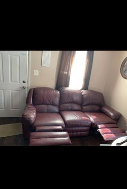 Double reclining maroon leather sofa