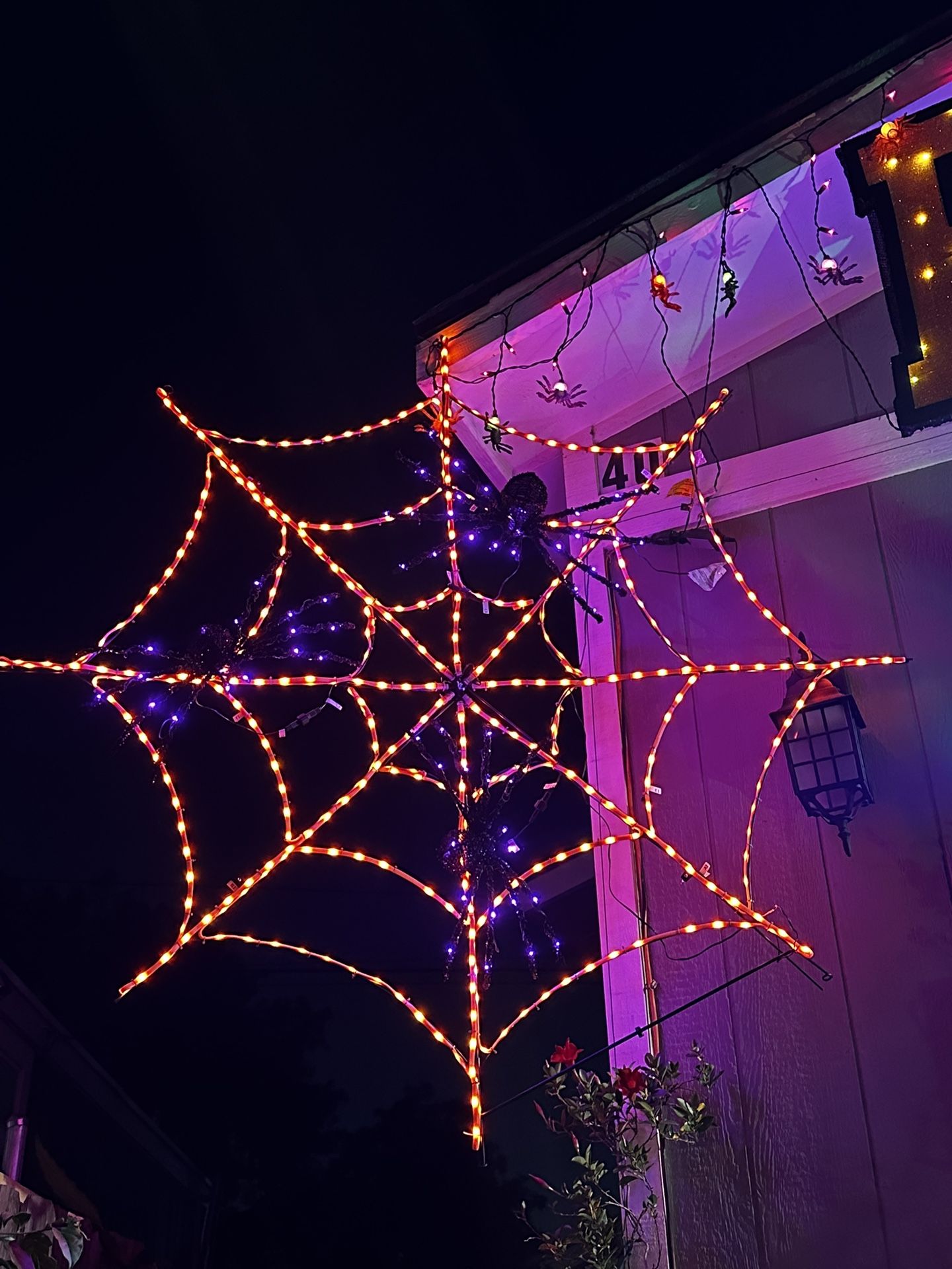 Haunted living 4ft Halloween Black Spiders on Orange Spider Web Decoration Outdoor Polyester, Ground Freestanding, Plug-In