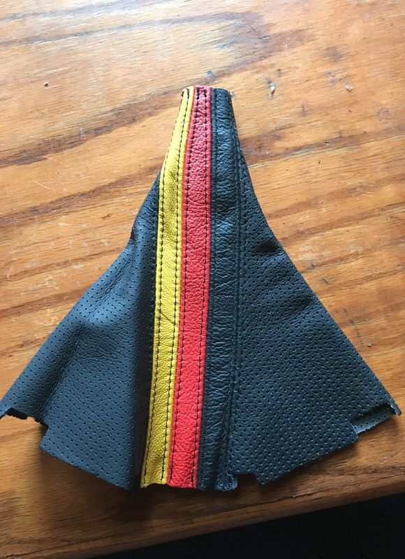 VW leather shifter boot with German flag colors