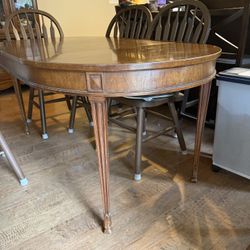 Vintage extendable wooden dining table with 6 chairs for $800