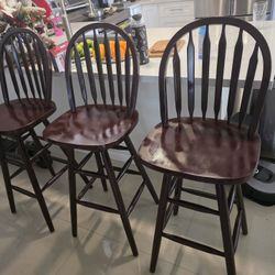 3 tall wooden chairs in mahogany color.Swilve 31in H
