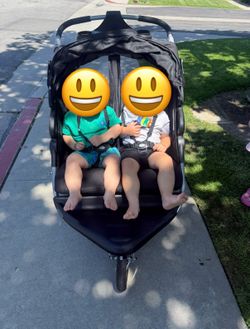 Double stroller side by side with sun shade and drink holders