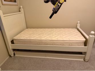 Twin bed with mattresses and trundle