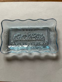 This is a blue dish called “The Last Supper” measuring 5 /1/2” by 3 / 1/2” No chips, breaks orchips