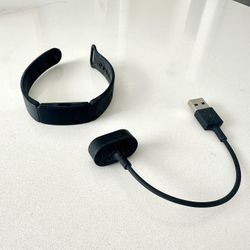  Fitbit Inspire HR fitness tracker with its USB charging cable $25