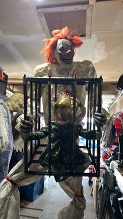 Animatronic clown with child in cage