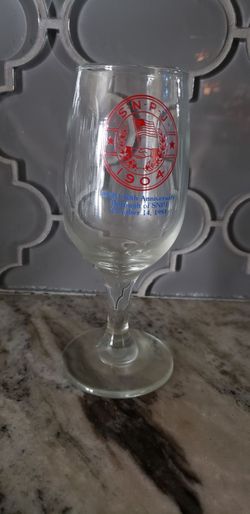 a clear stemmed souvenir glass commemorating the 50th anniversary of the Borough of SNPJ in 1984