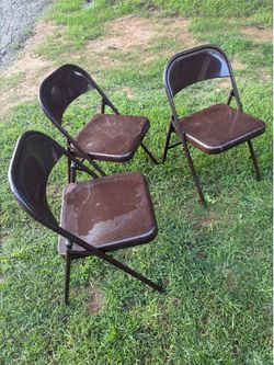 Three metal folding chairs.