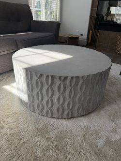 Stylish round coffee table with a unique patterned design. - cement 