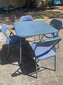 Nice blue folding  table with 4 folding chairs( table is 33 inch L x 33 in W x 29 in H