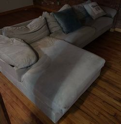 large, L-shaped fabric sectional sofa with a chaise lounge and saccent pillows,