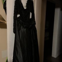 Net jumpsuit with a satin attachable skirt.