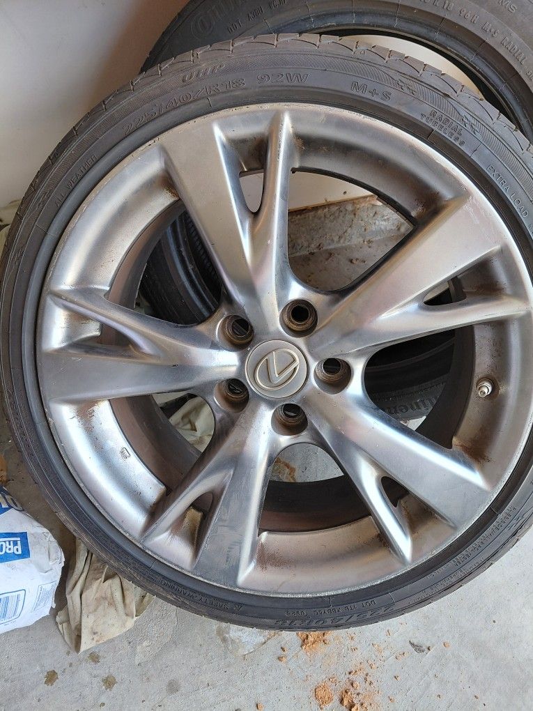 2 18" Lexus Rims With A New Tire On One