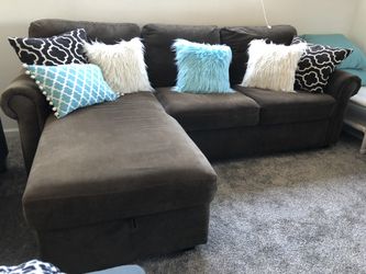Dark brown sectional w storage and a bed