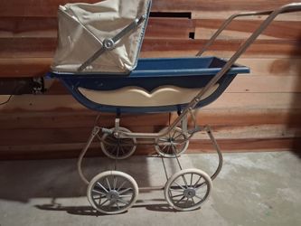This is a vintage 1950s South Bend metal baby stroller carriage in light blue.